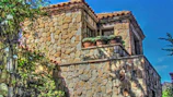 Close-up of rustic stone architecture blending with warm Mediterranean colors.