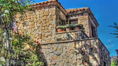 Close-up of rustic stone architecture blending with warm Mediterranean colors.