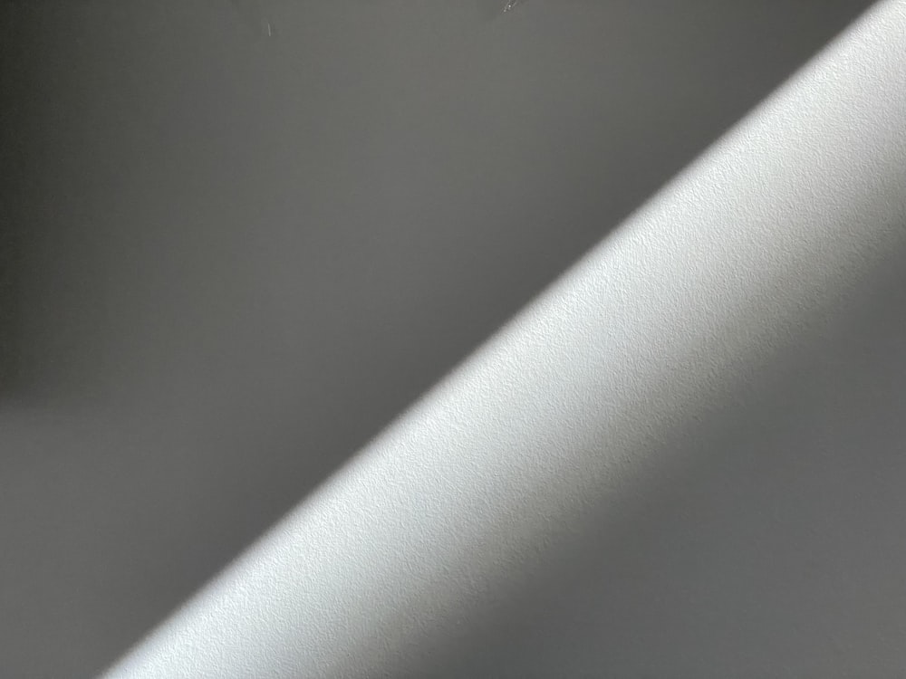 a close up of a white wall with a light shining on it