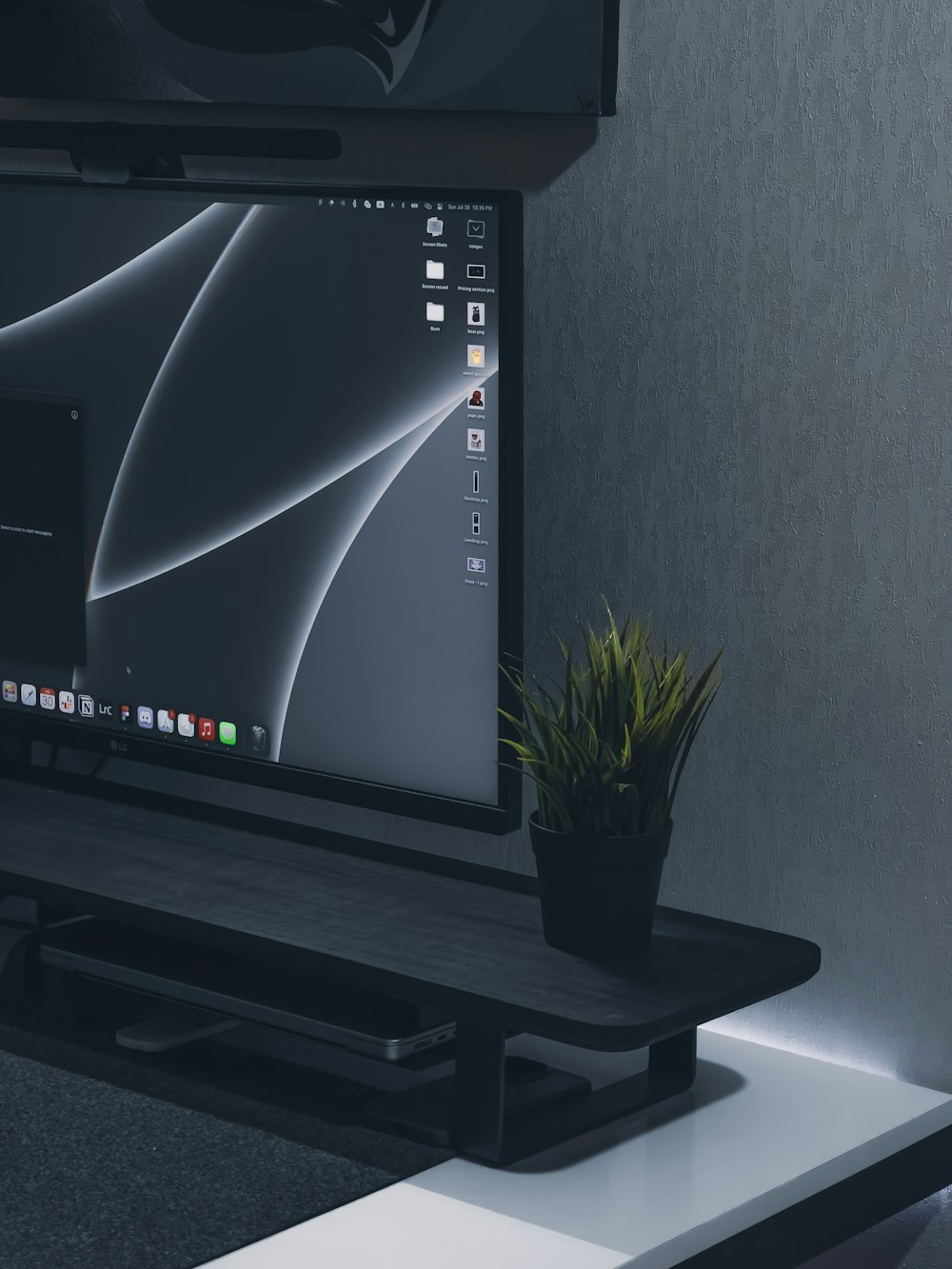 a flat screen tv sitting on top of a white table