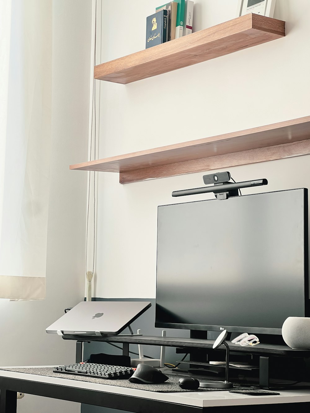 a computer desk with a monitor, keyboard and mouse