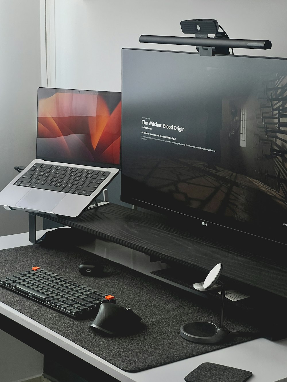 a desk with a laptop and a monitor on it