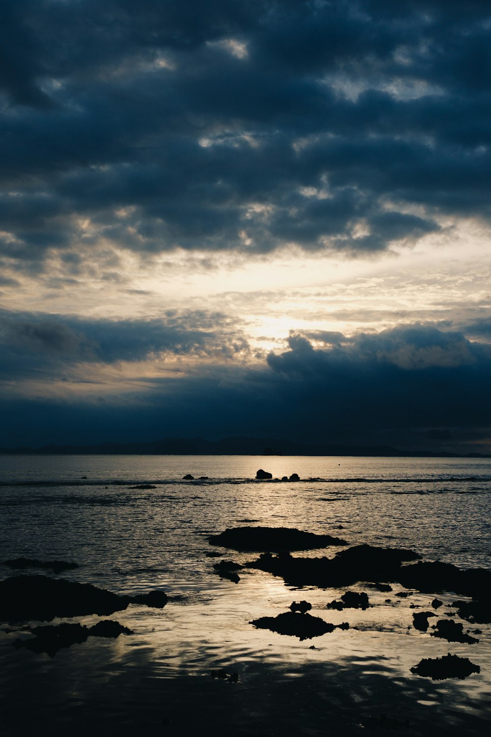 a large body of water under a cloudy sky