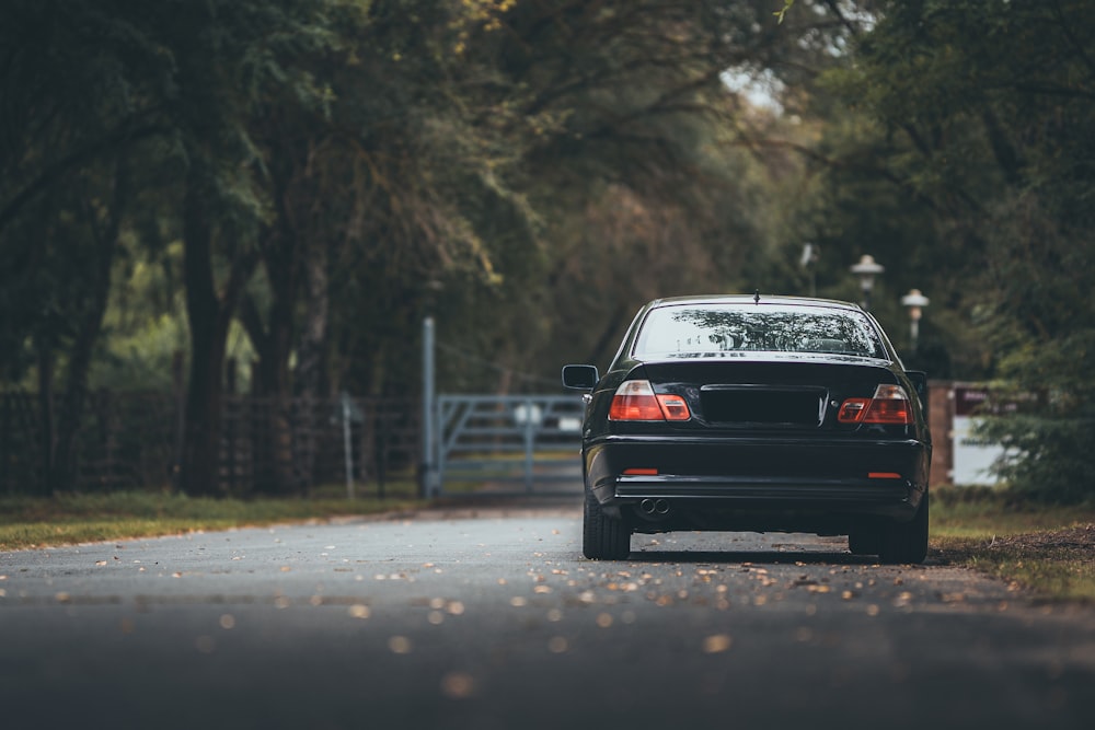 a black car parked on the side of a road