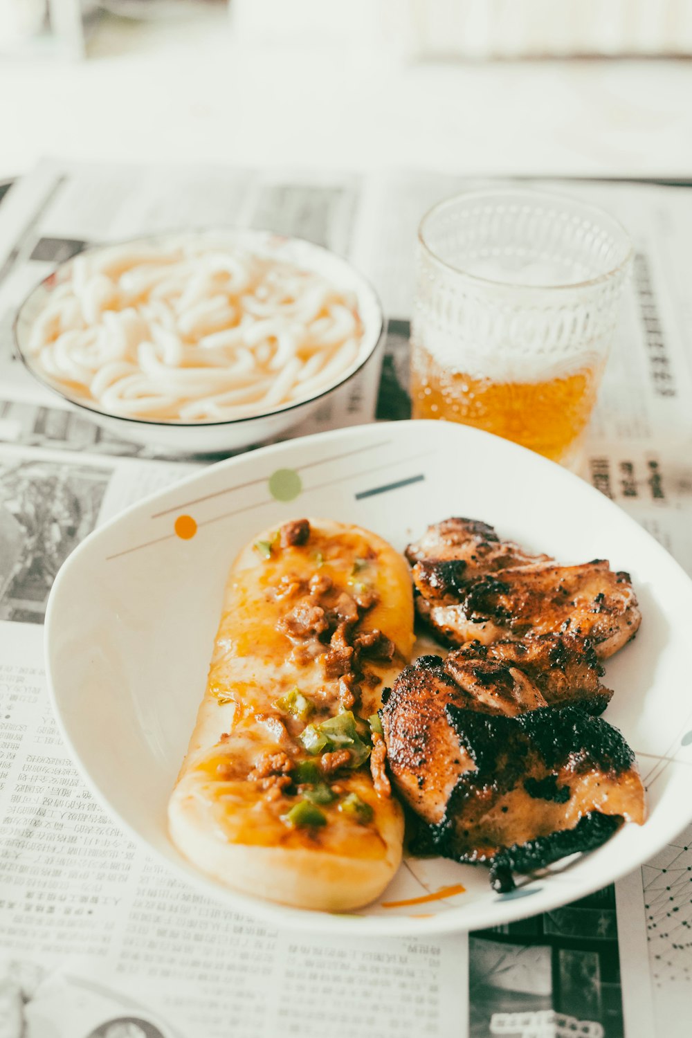 a plate of food on a table with a glass of beer