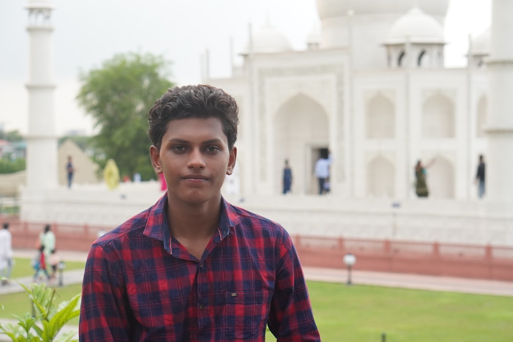 a man standing in front of a white building