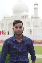 a man standing in front of a white building