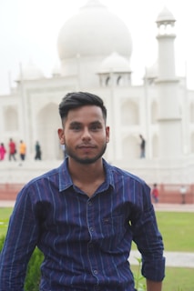 a man standing in front of a white building