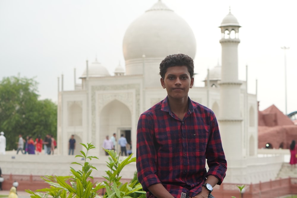 a man standing in front of a white building