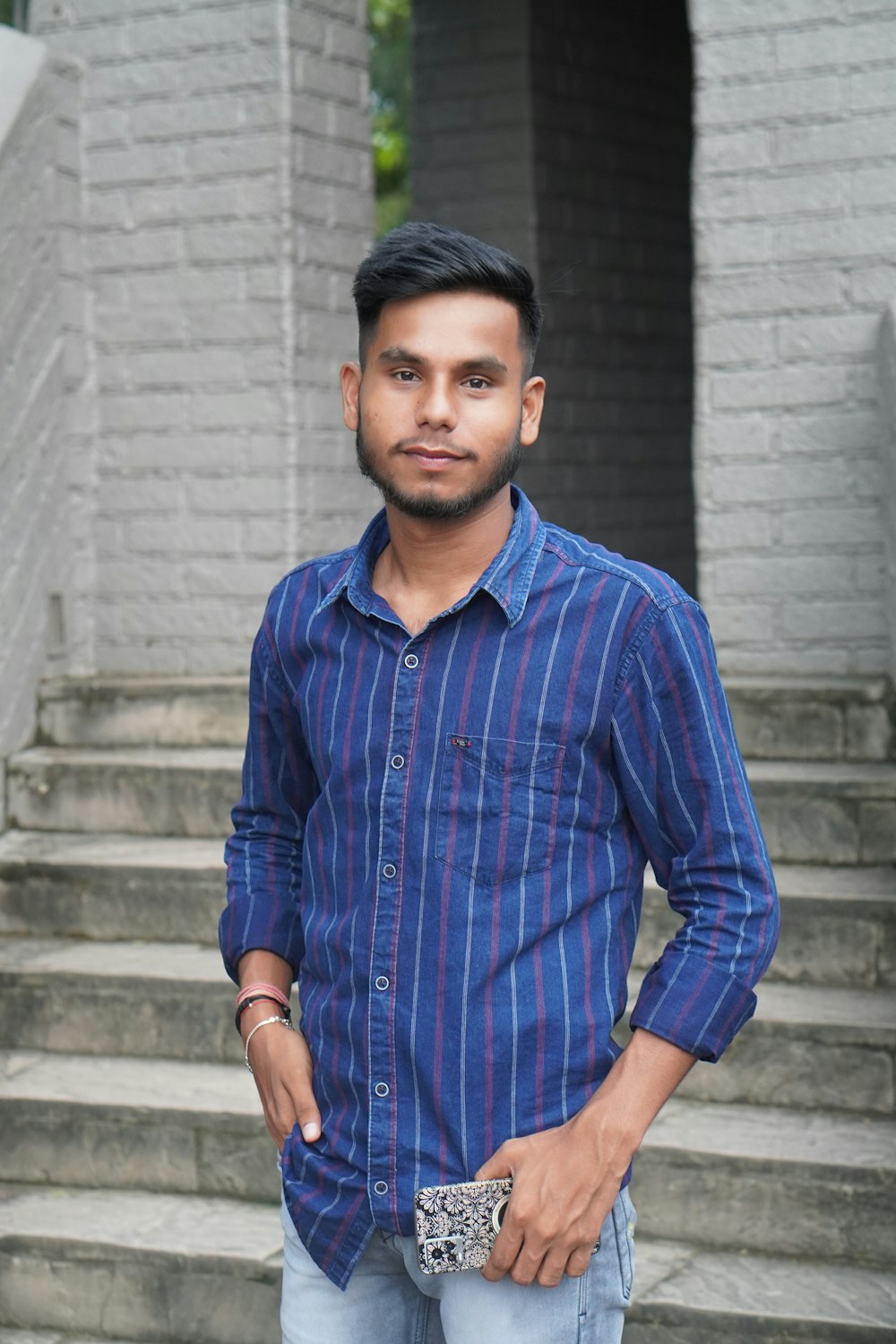 a man standing in front of a set of stairs