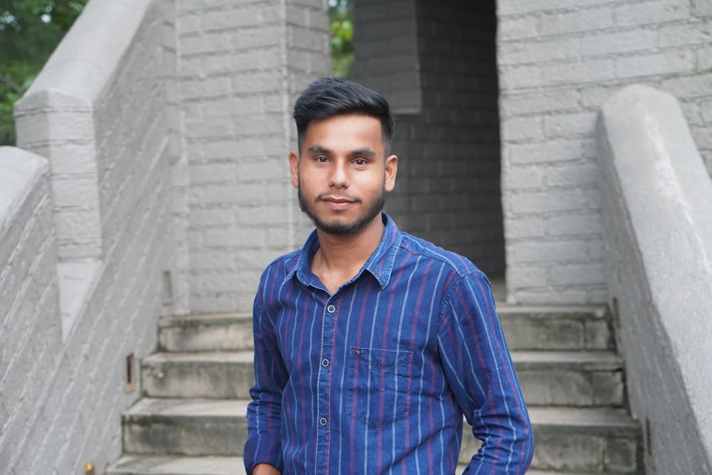 a man standing in front of a set of stairs