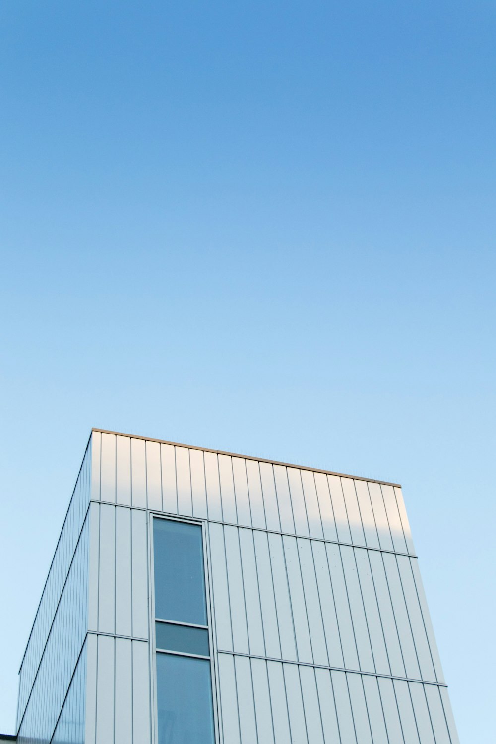 an airplane flying in the sky over a building