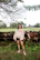 A happy client standing next to a well-maintained livestock facility.