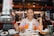 A happy customer enjoying a meal served by a robot at Americano Bot Bistro.