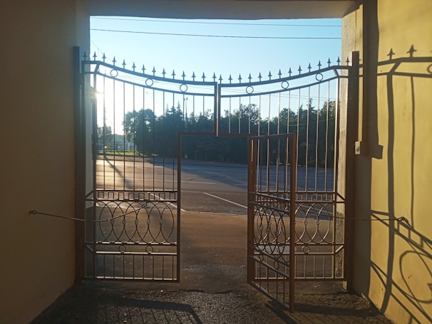 A wide-angle view of a commercial property’s large entry gate during the day.