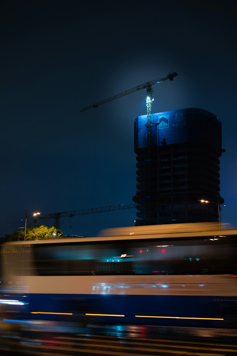 a train passing by a building under construction