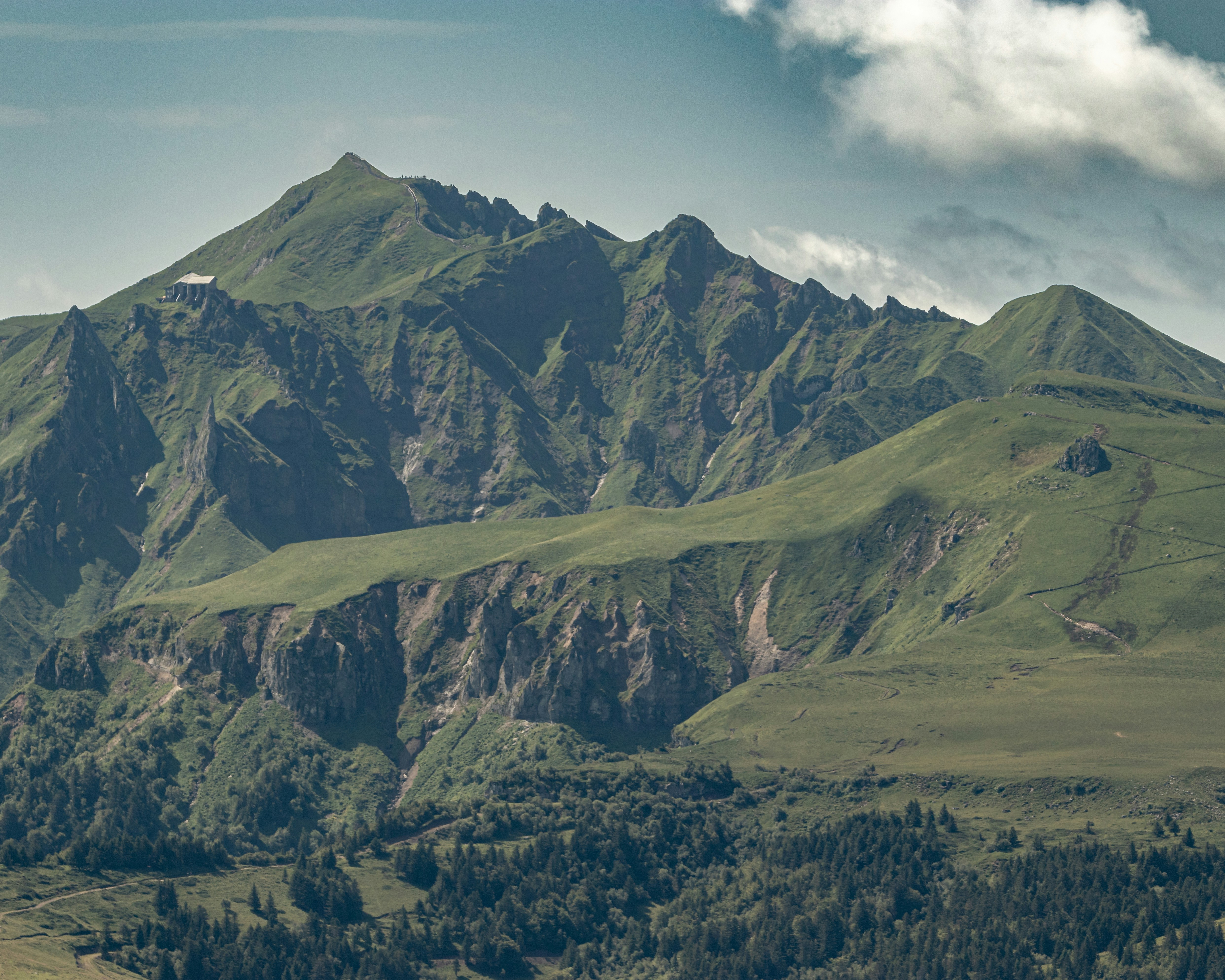a mountain range with a few trees in the foreground
