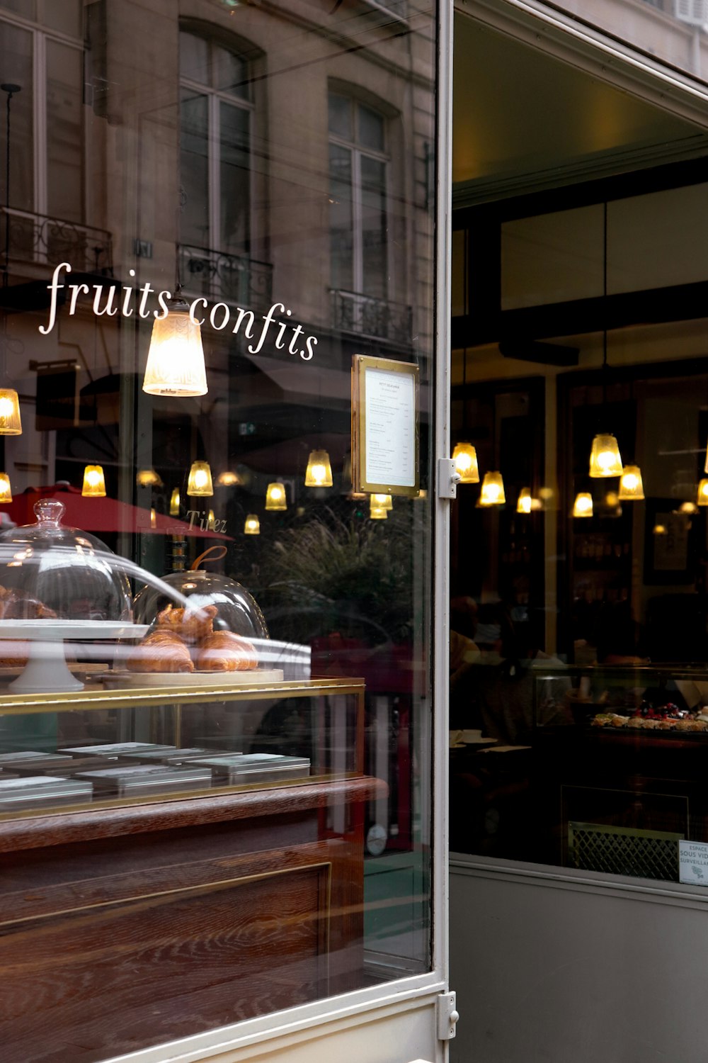 Un frente de tienda con un escaparate de frutas y dulces