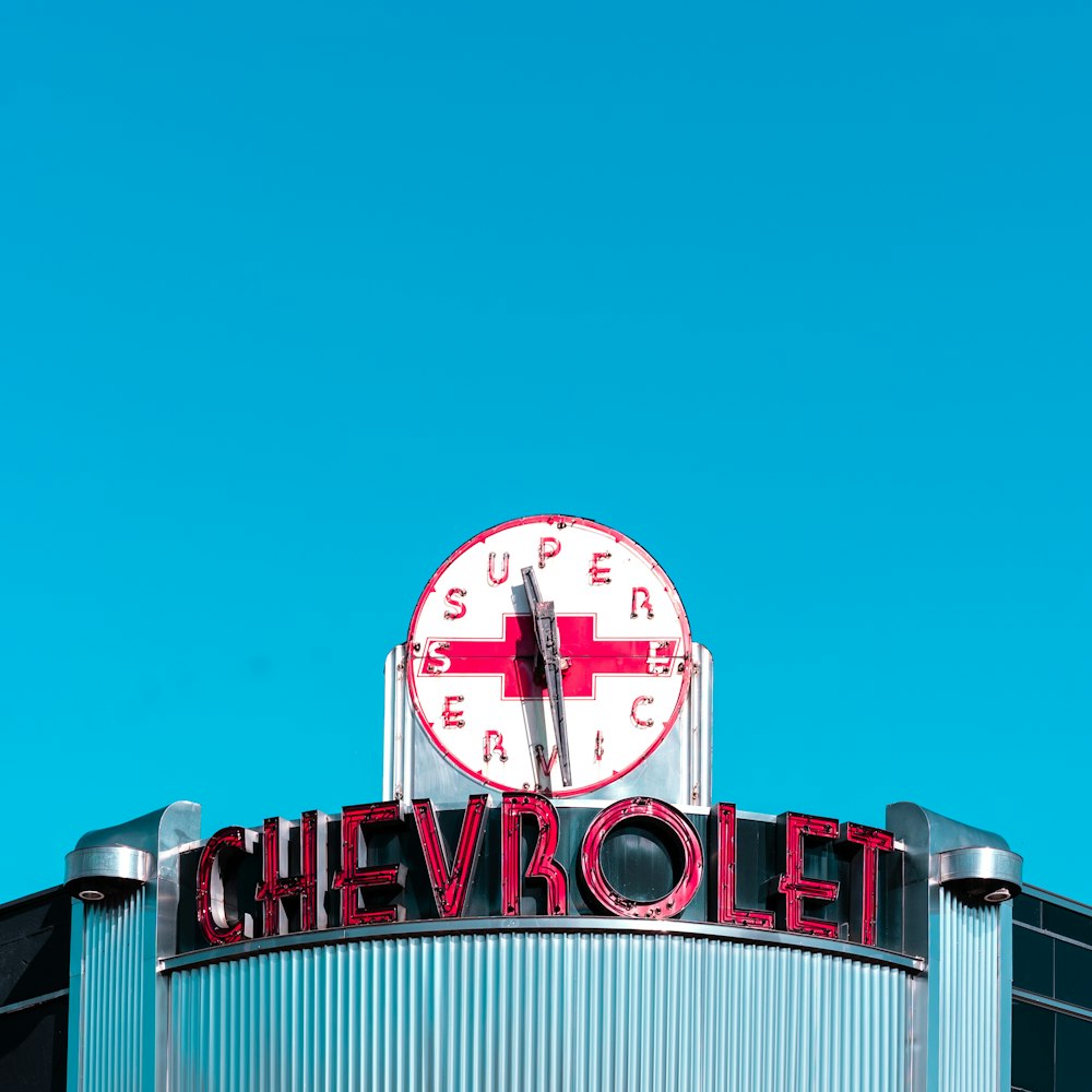 a red and white clock on top of a building