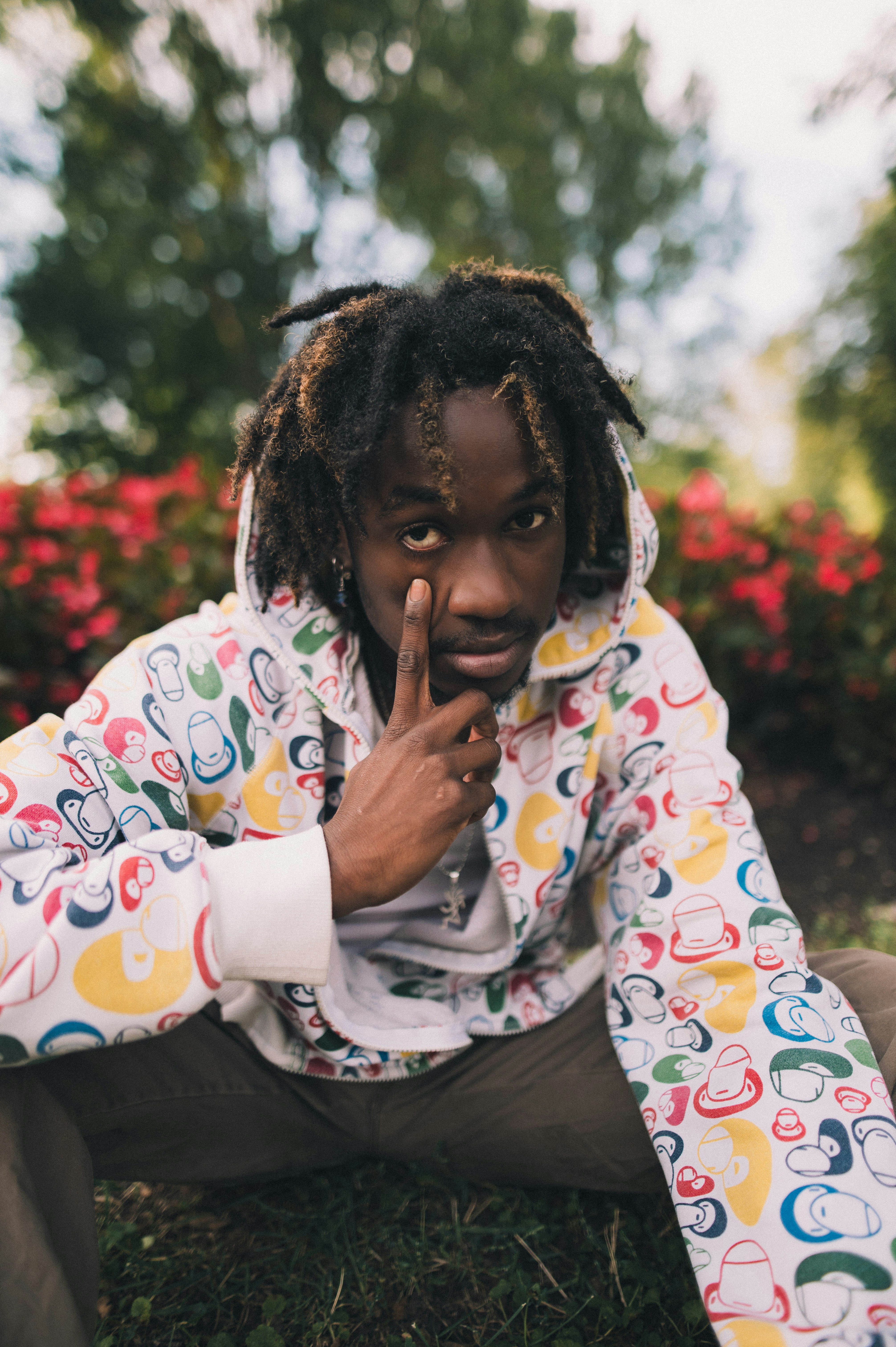 a man with dreadlocks sitting on the ground