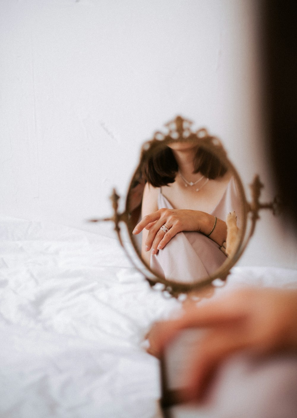 a woman looking at her reflection in a mirror