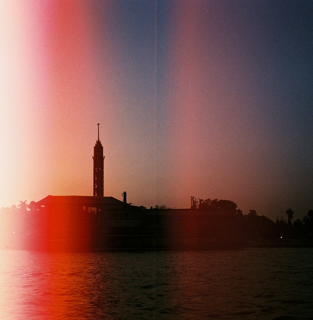 a large body of water with a clock tower in the background