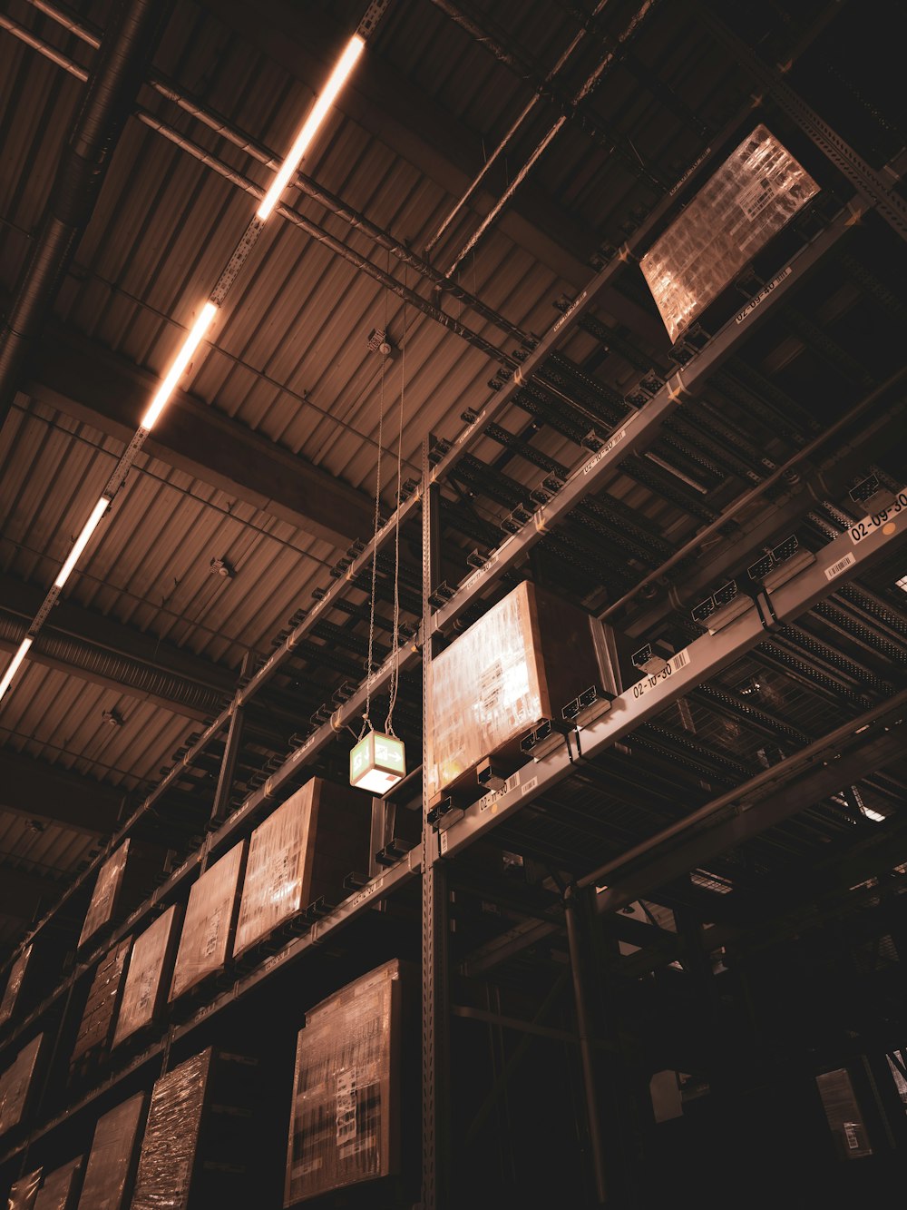 a light hanging from a ceiling in a warehouse