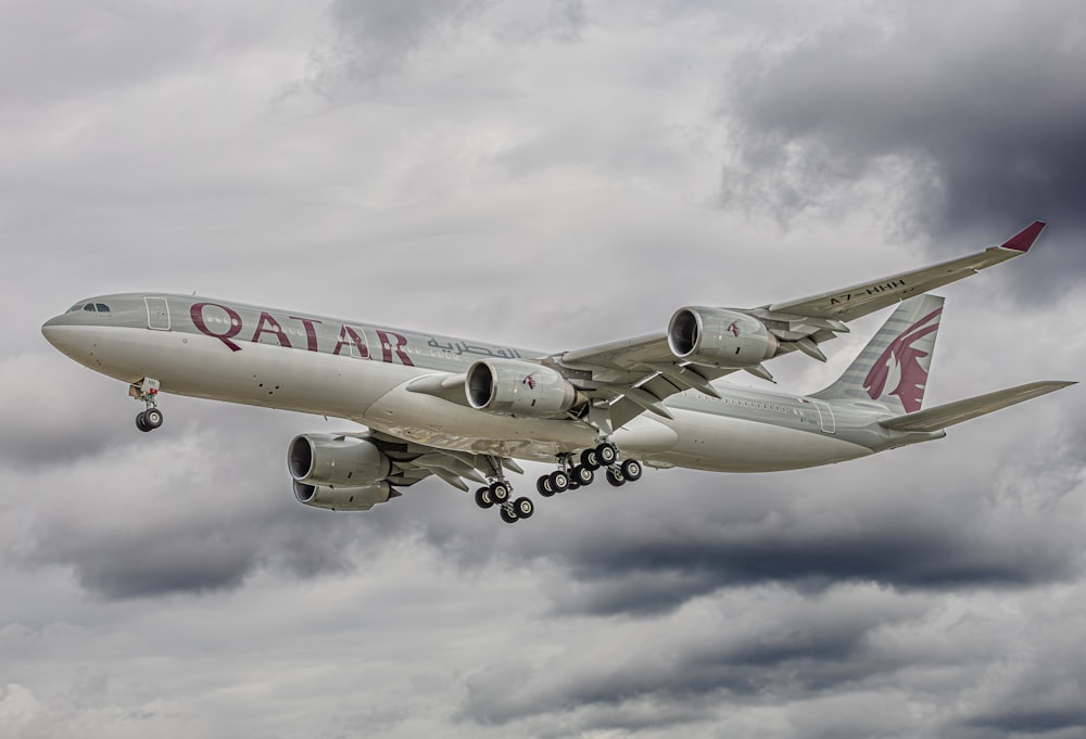 a large jetliner flying through a cloudy sky