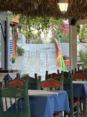A charming outdoor dining area at a local pousada, bathed in warm afternoon light.