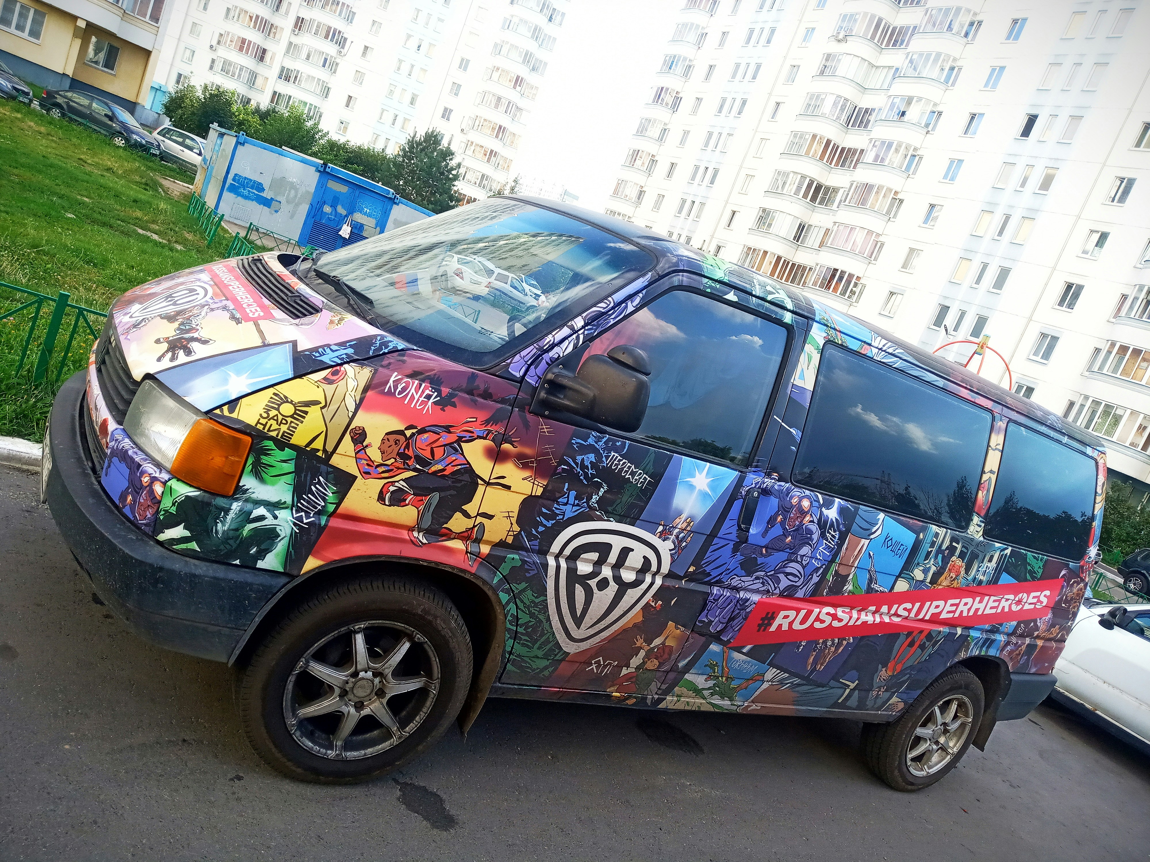 a multicolored van parked in a parking lot