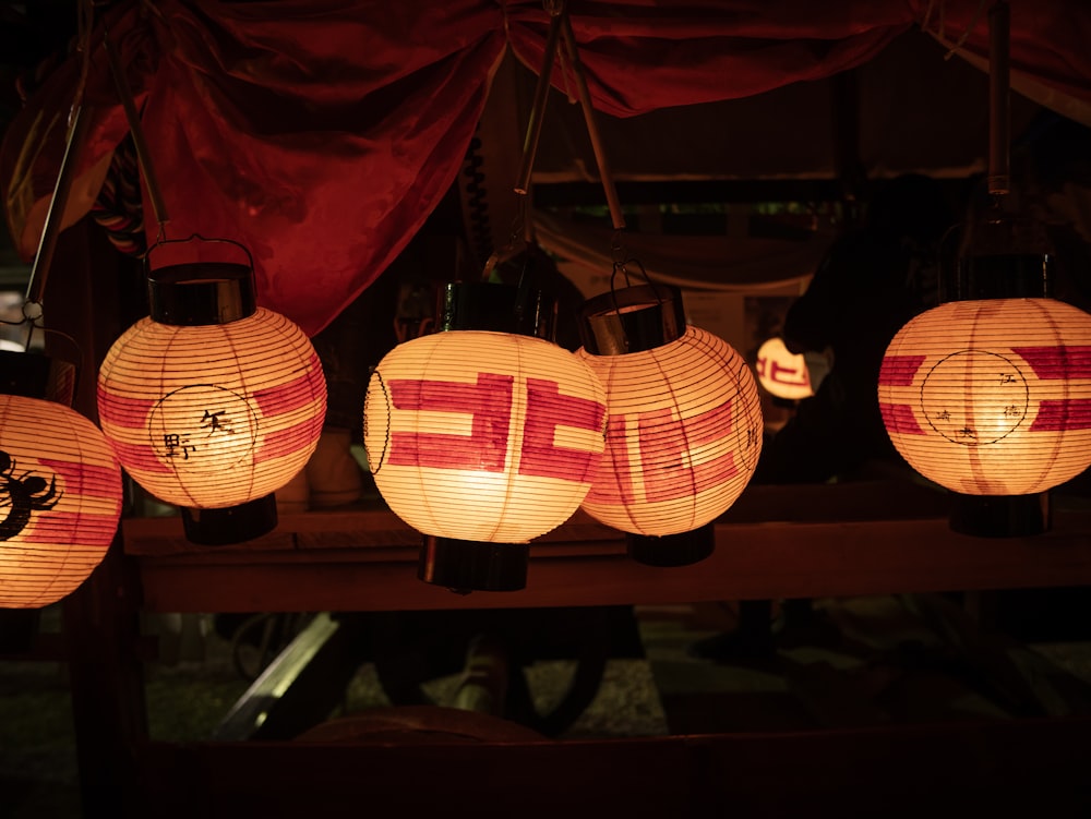 a group of paper lanterns hanging from a ceiling