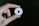 a hand holding a white paper cut out of a video play button