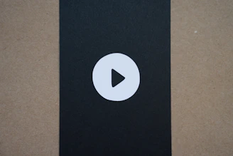 A sleek black and yellow themed download button icon.