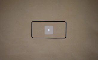 Dark navy SaaS card with cyan accents displaying a two-column layout: left side with status rows and right side with a large rounded video placeholder featuring a play icon.