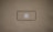 A blank brown background with a black rectangle outline in the center. Inside the outline, there is a light gray play button icon.