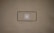 A blank brown background with a black rectangle outline in the center. Inside the outline, there is a light gray play button icon.