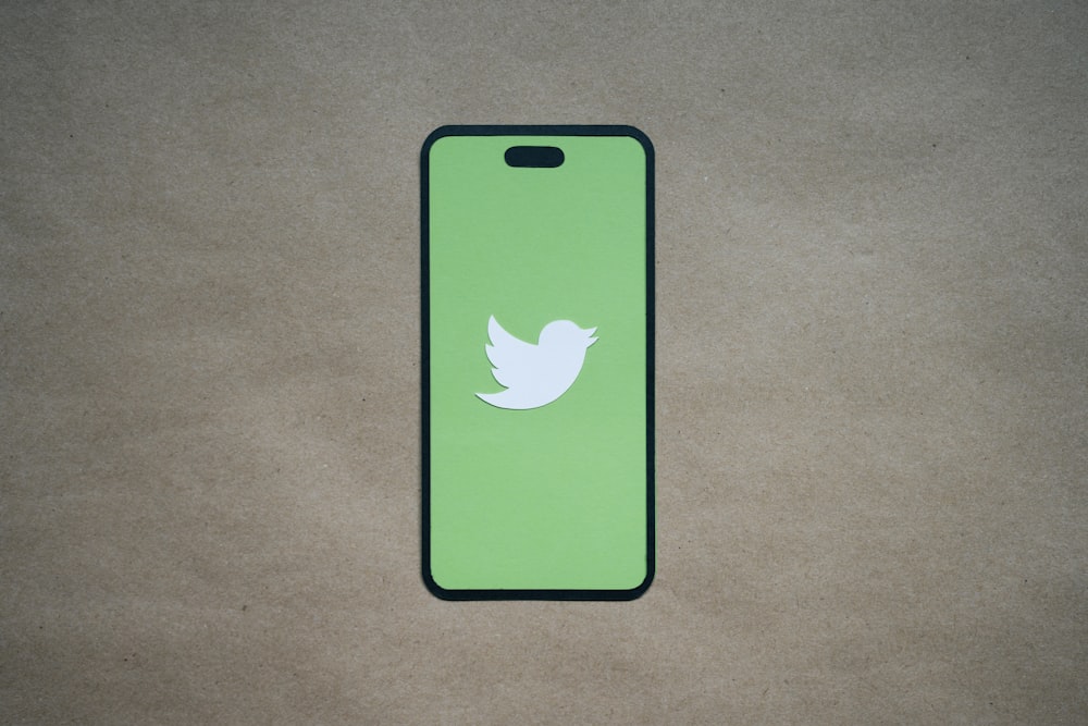 a green phone case with a white bird on it