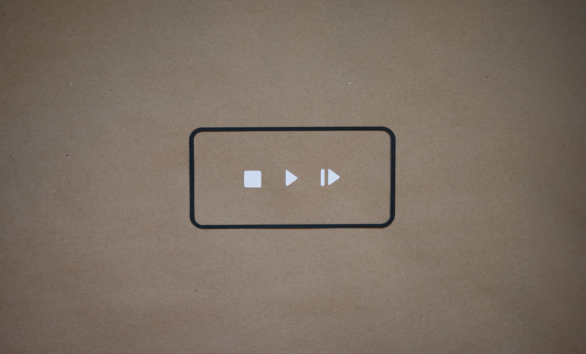 a black and white button on a brown background