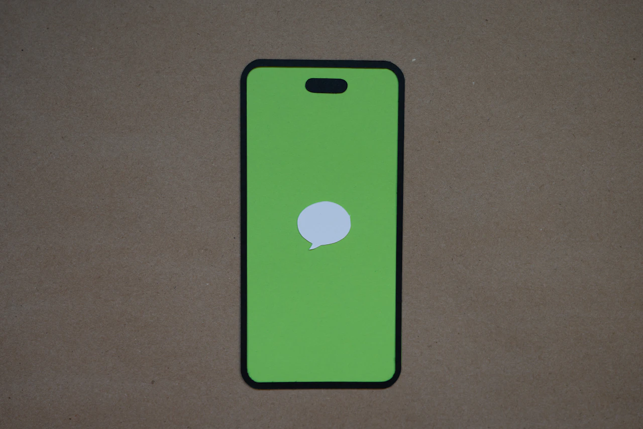 A phone showing a single message bubble, the SMS channel dispensaries use for time sensitive offers