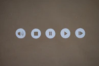 Horizontal audio player bar with six headphone icons lined up for English exercises.