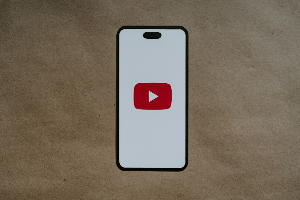 a white phone with a red youtube logo on it