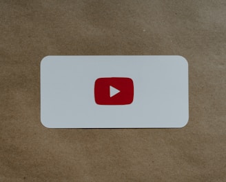 a white card with a red youtube logo on it