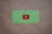A green card with rounded corners features a prominent red play button symbol in the center, set against a plain brown textured background.
