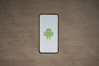 a cell phone with a green icon on it
