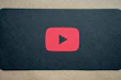 Dynamic video play button with psychedelic color bursts behind it