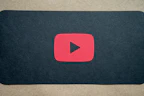 Dynamic video play button with psychedelic color bursts behind it