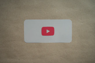 A sleek dark-themed card showing a video course thumbnail with a play button overlay