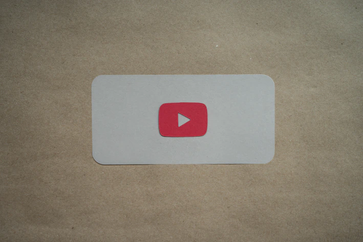 A sleek dark-themed card showing a video course thumbnail with a play button overlay