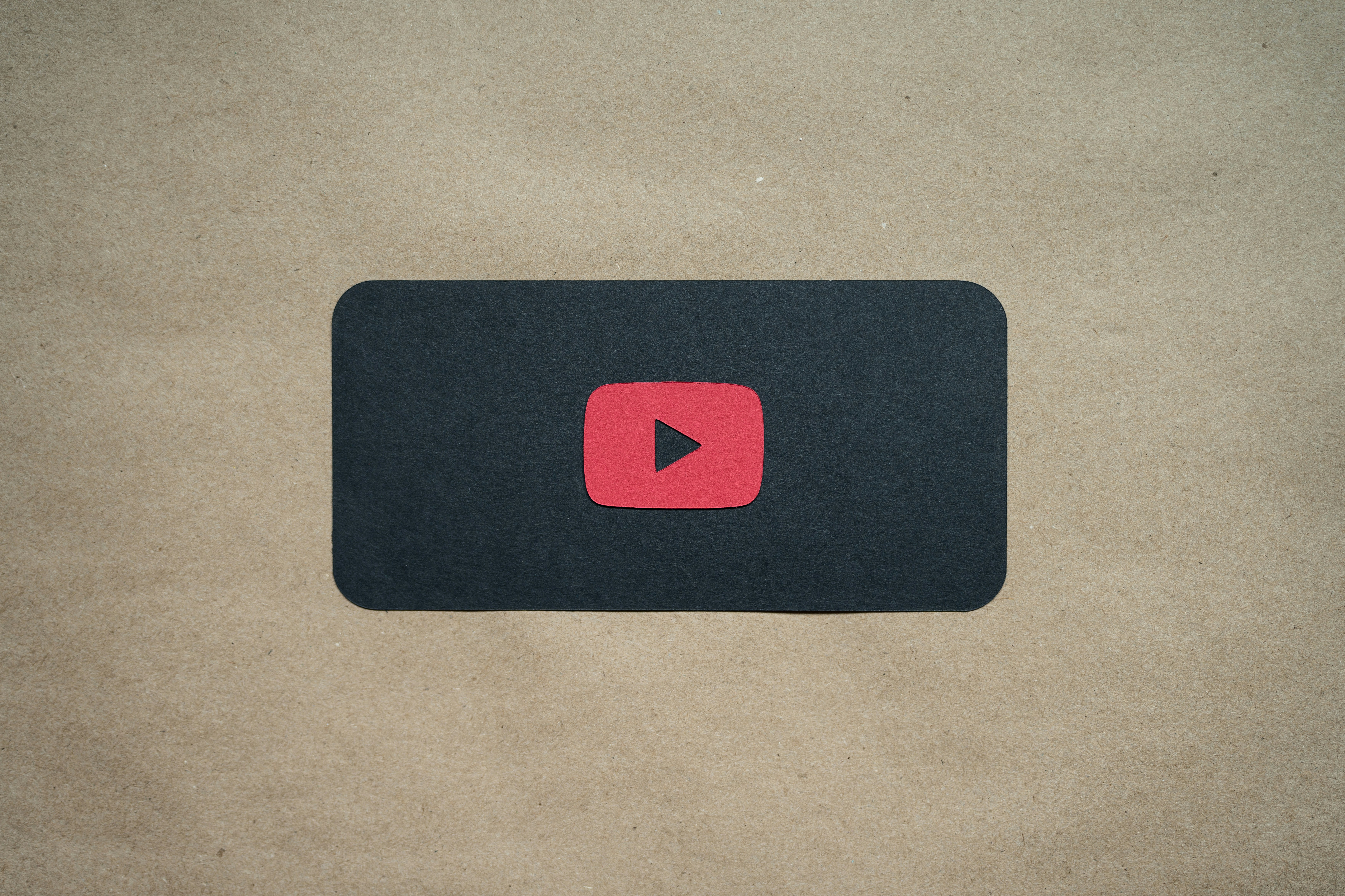 a black square with a red youtube logo on it