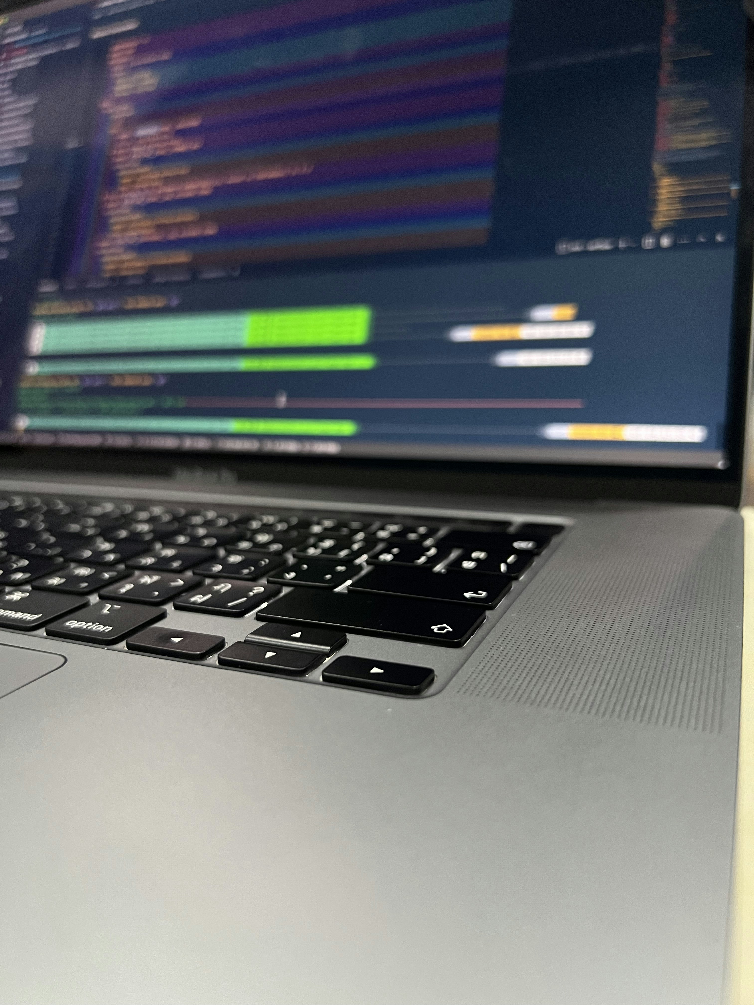 A close-up of a person using a laptop with digital technology graphics in the background.